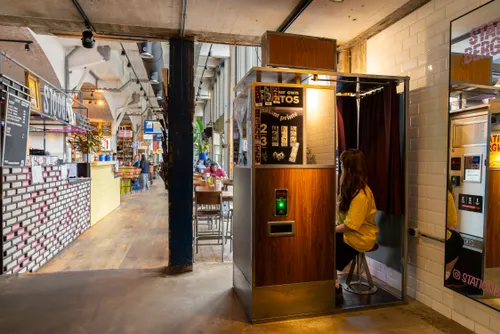 Visitor using a classic digital photobooth inside Station Bergweg, a creative hotspot in Rotterdam.