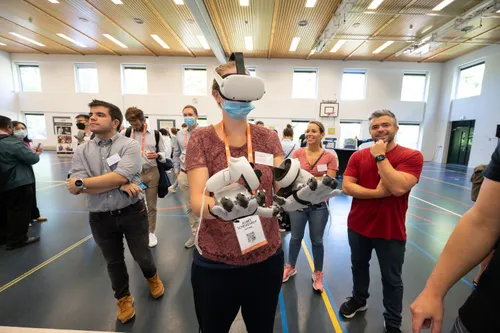 Photo of a woman in XR gear, with people watching her