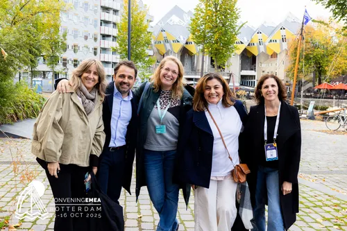 Photo of a group o PCMA EMEA delegates on a city exploration tour, posing near the famous cube houses