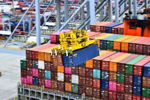 Containers being lifted onto a ship at one of the terminals in the Port of Rotterdam.
