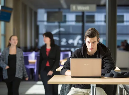 Photo of a student at work behind his laptop at Erasmus University Rotterdam