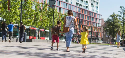 Photo of a mother with two young children walking at Kruisplein in Rotterdam's city centre.