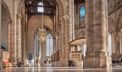 Laurenskerk Rotterdam interior: Gothic arches, stone pillars and stained-glass windows illuminate the spacious church nave.
