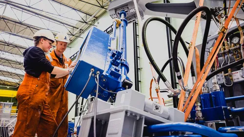 Photo: two young workers developing innovative maritime solutions at Ampelmann, located at RDM Rotterdam.