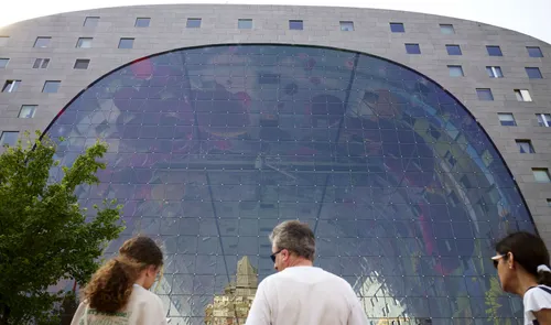Een foto van mensen voor de Markthal in de zomer