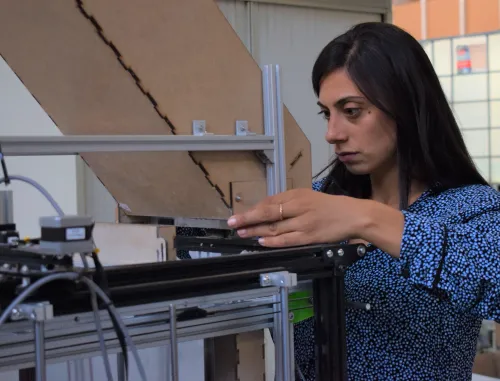 Photo of Coastruction founder Nadia Fani, inspecting the Asterix 3D printer