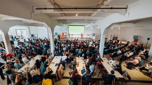 Captivated audience listening to a speaker on stage during Placemaking Europe