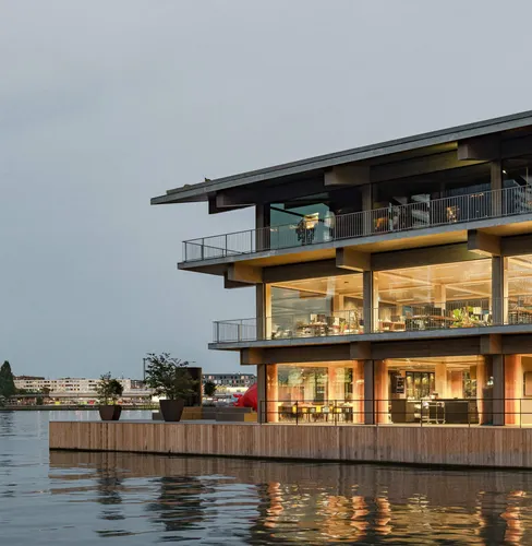 Photo of part of the exterior of the Floating Office Rotterdam, seen during the 'golden hour' with beautiful light