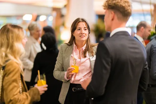 Photo: Red Carpet Dinner 24 at De Doelen ICC, welcoming newly arrived international companies to Rotterdam. We see people conversing.
