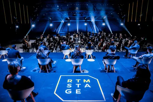 Photo of people on stage at RTM  Stage of Rotterdam Ahoy Convention Center. We also see the audience.