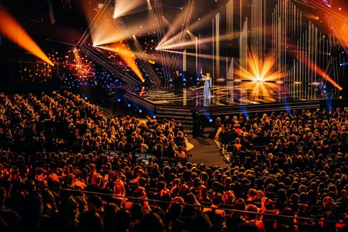 Photo of an event at Ahoy Rotterdam. We see a captivated audience and lighting.