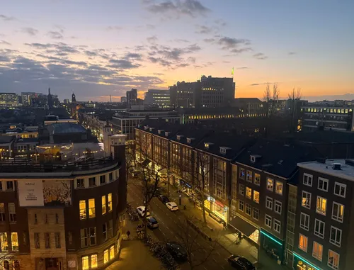 Photo of the sunrise over Rotterdam city centre, as seen from the 42workspace rooftop terrace