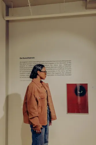 A photo of a woman looking at art.