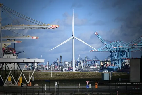 Photo of traditional fossil industry and a large modern wind turbine