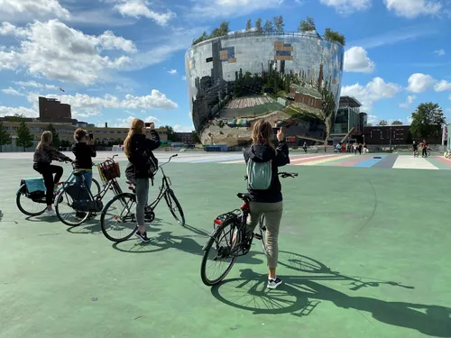Photo of people on bikes taking photos of the Depot building during a tour