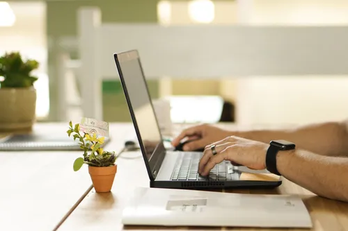 Photo of hands behind a laptop