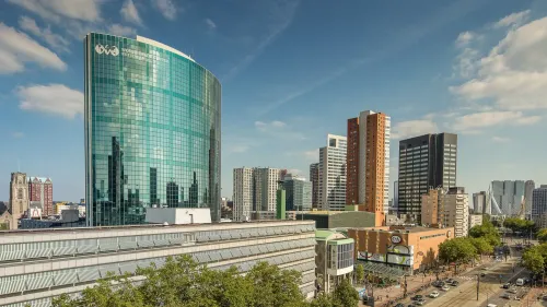 Skyline view of Rotterdam featuring the World Trade Center, home to the Postillion Hotel & Convention Centre, with modern high-rises in the background.