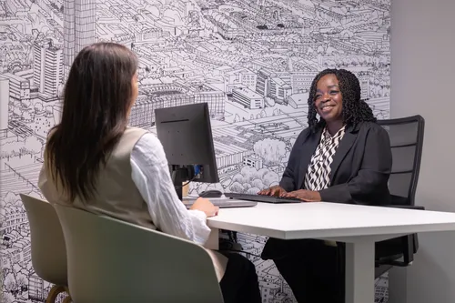 Photo of a woman at a desk of Rotterdam International Center